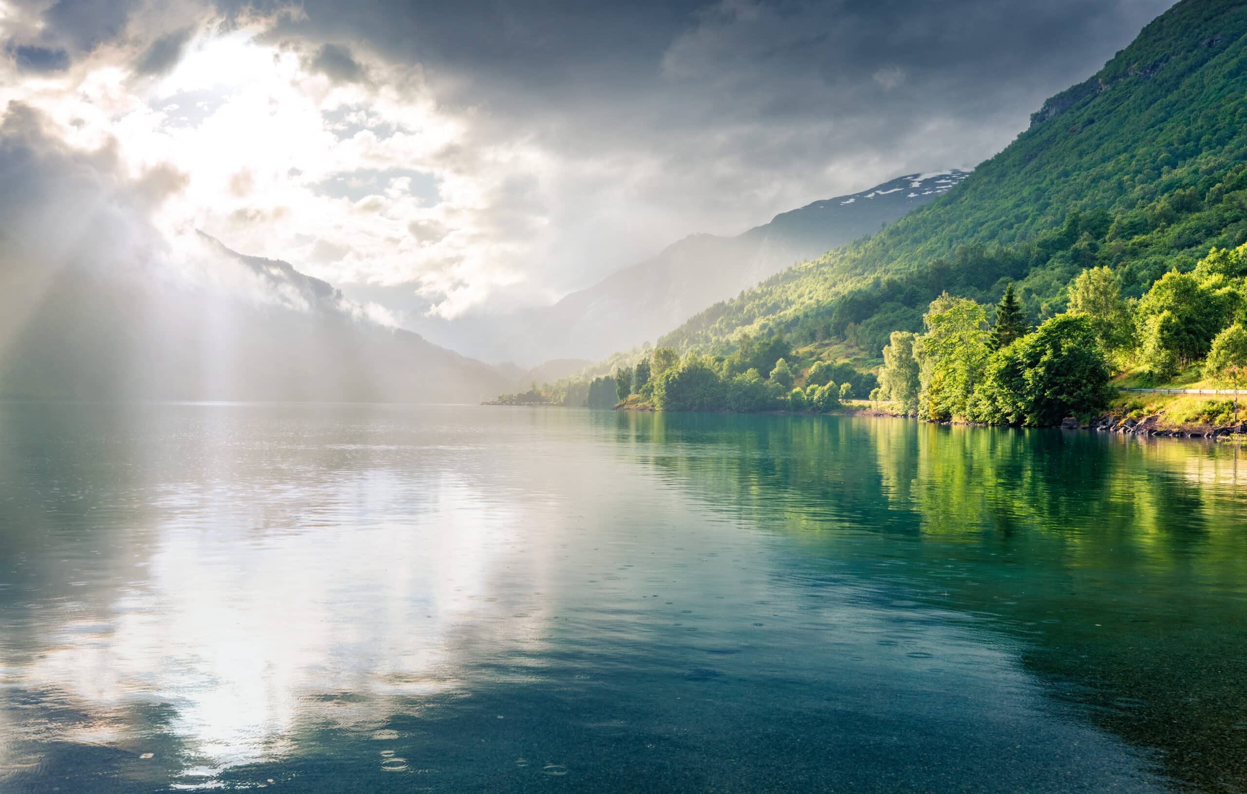 Fantastic summer view of Lovatnet lake, municipality of Stryn, Sogn og Fjordane county, Norway. Colorful rainy scene in Norway. Beauty of nature concept background.